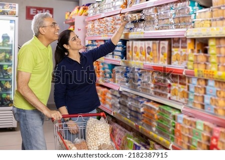 Portrait of indian couple at grocery store while shopping. Royalty-Free Stock Photo #2182387915