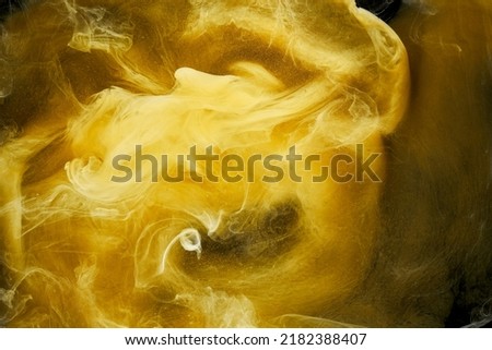 Liquid fluid art abstract background. yellow dancing acrylic paints underwater, space smoke ocean