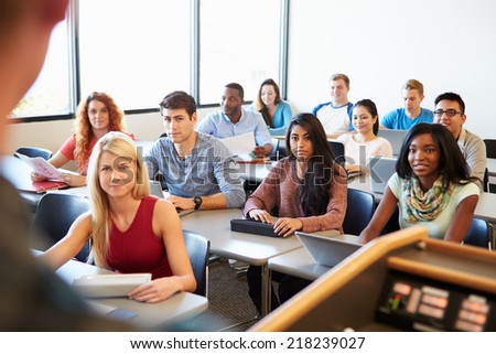 University Students Using Digital Tablet And Laptop In Class