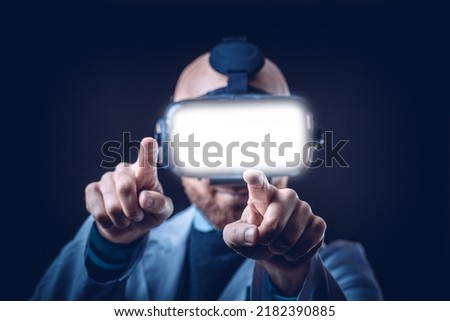 Photo of male doctor with 3d glasses with black background and medical white coat