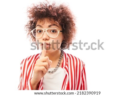 Young positive kazakh girl with afro hairstyle put finger on lips shh keep silence and secret isolated on white background