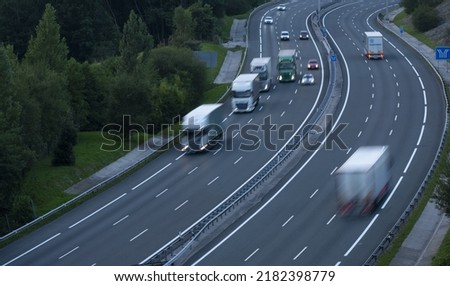 Aerial view of trucks driving on the highway Royalty-Free Stock Photo #2182398779
