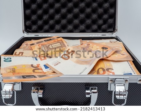 The suitcase is full of euro banknotes. Concept Investments, bribes, corruption. Royalty-Free Stock Photo #2182413413