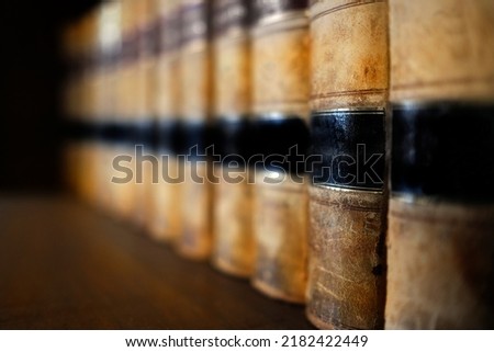 Old leather law books or lawbooks stacked on shelf