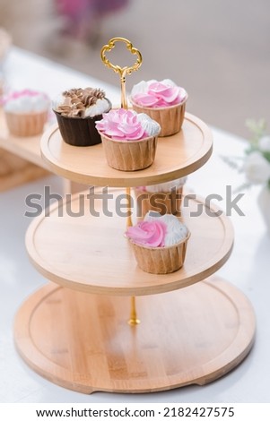 many cup cake on wood shelf in wedding ceremony and birthday party.concept for food and desert in party.vertical image