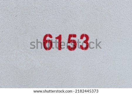 Red Number 6153 on the white wall. Spray paint.
