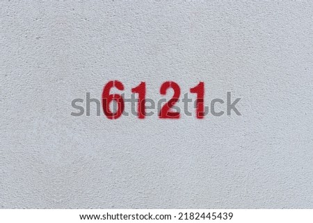 Red Number 6121 on the white wall. Spray paint.
