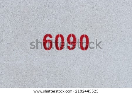 Red Number 6090 on the white wall. Spray paint.
