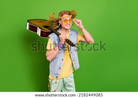 Photo of youngster guy wander musician hold guitar wear denim stylish jeans vest isolated bright color background