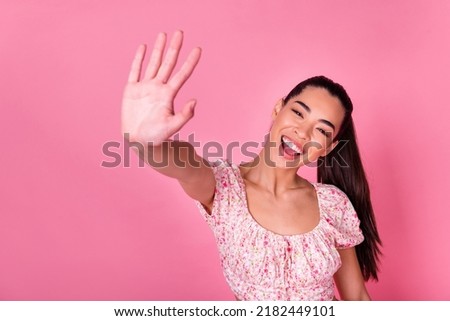 Portrait of pretty excited girl arm palm give high five toothy smile isolated on pink color background Royalty-Free Stock Photo #2182449101