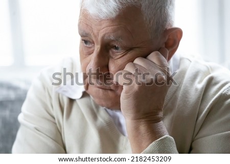 I miss you... Desperate elderly male widower mourning trying to be strong after loss of beloved wife. Upset hoary aged man prop cheek with hand suffer from heavy thoughts depression chronic diseases Royalty-Free Stock Photo #2182453209
