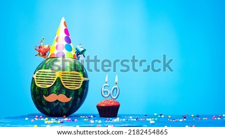 Creative happy birthday greeting with muffin festive garlands decoration. Fan greeting card. Copy space. Beautiful happy birthday background with burning candles with number 60