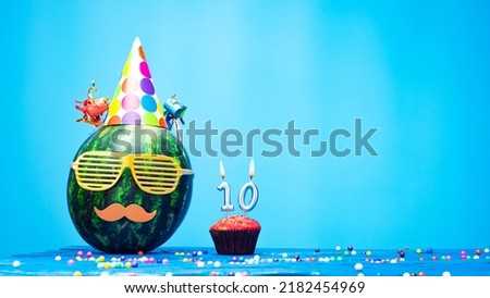 Creative happy birthday greeting with muffin festive garlands decoration. Fan greeting card. Copy space. Beautiful happy birthday background with burning candles with number 10.