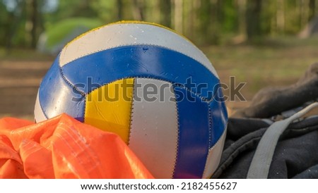 Close-up view of ball for volleyball in the forest. Leather ball. Forest camping area. Nature background.