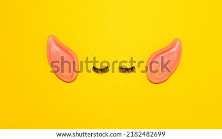 man with big ears, creative minimal concept on yellow background