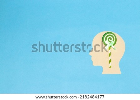 paper head with brain lollipop, creative art design and copy space, blue background