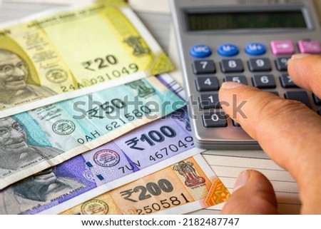 Indian money, expense or profit calculation, new banknotes, rupee, financial business concept