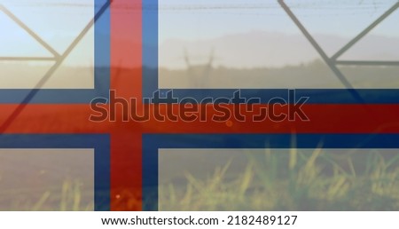 Image of flag of faroe islands over pylons. ukraine crisis and international politics concept digitally generated image.