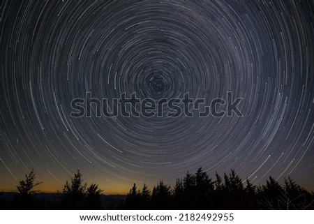 Night sky rotating around polaris(north star)  90 Images at 30 sec exposures stacked. Royalty-Free Stock Photo #2182492955