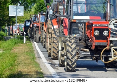 Column of tractors at protests. Farmers at demonstrations. Blocking the road with tractors. Royalty-Free Stock Photo #2182498487