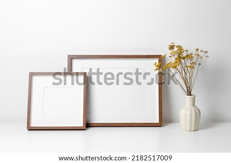 Two wooden frames mockup in white minimalistic room with copy space for artwork, photo or print presentation