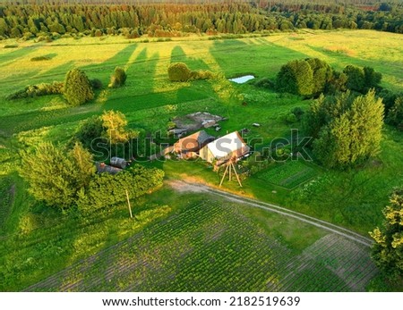 Village wooden house. Country houses in countryside, aerial view. Rural building and farmhouse in countryside. Сountry House. Suburban house in rural. Roofs of village home. Agricultural development. Royalty-Free Stock Photo #2182519639