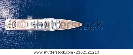 Aerial drone ultra wide panoramic photo with copy space of mega luxurious yacht with wooden deck anchored in Aegean island deep blue sea Royalty-Free Stock Photo #2182521213