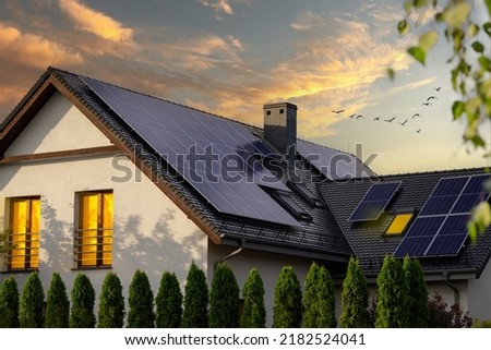 Modern house with solar panels. Night view of a beautiful white house with solar panels. Royalty-Free Stock Photo #2182524041