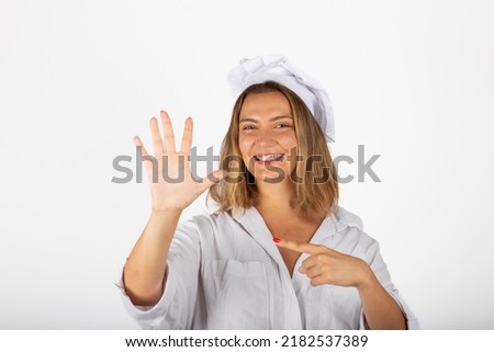 Beautiful smiling woman chef portrait in studio with five tips and tricks gesture
