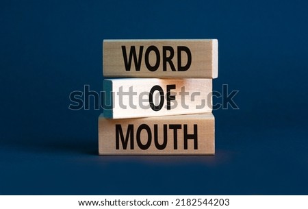 Word of mouth symbol. Concept words Word of mouth on wooden blocks on a beautiful grey table grey background. Business, finacial and word of mouth concept. Copy space.