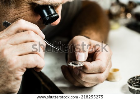 Clockmaker repairing wrist watch. Macro shot. Royalty-Free Stock Photo #218255275