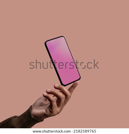 Mobile Phone Mockup Image. Screen as Empty. Hand levitating a Blank Display Smartphone. Clean and Minimal Styles Royalty-Free Stock Photo #2182589765
