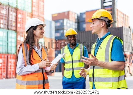 Caucasian business man and woman worker working in container terminal. Attractive engineer people processes orders and product at warehouse logistic in cargo freight ship for import export in harbor.