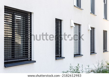 External Roller Blinds on Modern Windows Outside. External Shutters on Windows of House. Royalty-Free Stock Photo #2182612983
