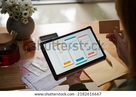 Closeup image of female customer paying for service subscription with credit card Royalty-Free Stock Photo #2182616667