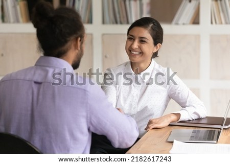 Multi racial business people shake hands start formal meeting in office. Happy Indian applicant get hired, handshake African HR manager finish successfully job interview. Business negotiations concept Royalty-Free Stock Photo #2182617243