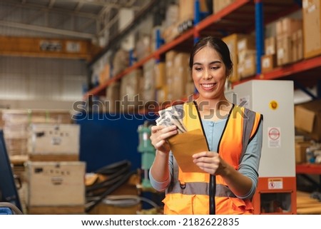 Worker employee recieve salary with working overtime bonus money payday work in factory warehouse Royalty-Free Stock Photo #2182622835
