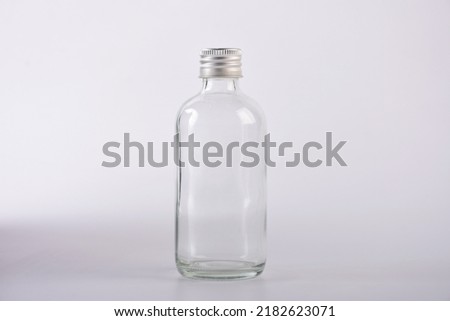 Empty glass bottle on white background.