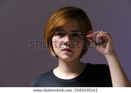 Beautiful Asian woman with short hair posing for a photo in the studio.with grain film noise.