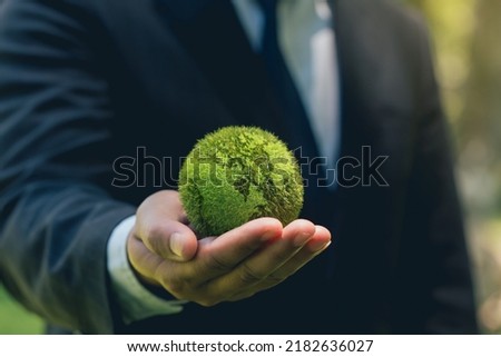 World Earth Day. ESG concept of environmental, social, and governance.Green Energy, Renewable and Sustainable Resources. Environmental and Ecology Care. Business Hand Holding Green  Globe.  Royalty-Free Stock Photo #2182636027