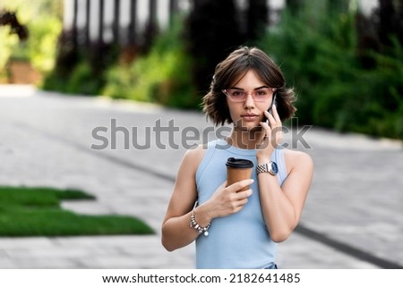 Portrait of a Successful Business woman Using iPhone 13 pro with coffee cup 