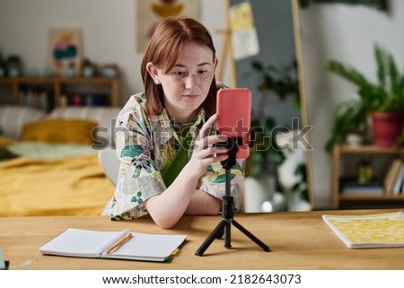 Girl turning on the record on her smartphone Royalty-Free Stock Photo #2182643073