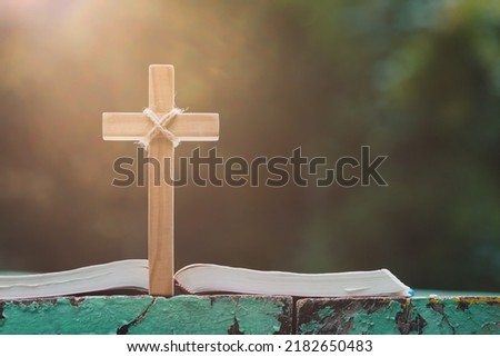 Open book on old wooden table with cross, religion concept, Power of hope or love and devotionreligion.
