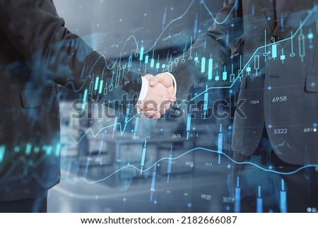 Close up of businessmen shaking hands with creative glowing forex chart hologram with map on blurry office interior background. Stock, teamwork, partnership, market and invest concept. Double exposure