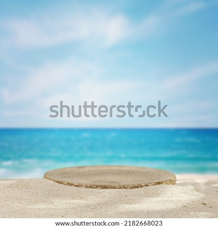 Stone pedestal in sand and sea landscape. Free space for your decoration. 