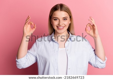 Photo of young pretty girl promoter show fingers okey symbol rate feedback ads isolated over pink color background.