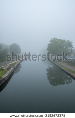 Beautiful spring sunrise over river banks. Morning fog in the forest. High quality photo