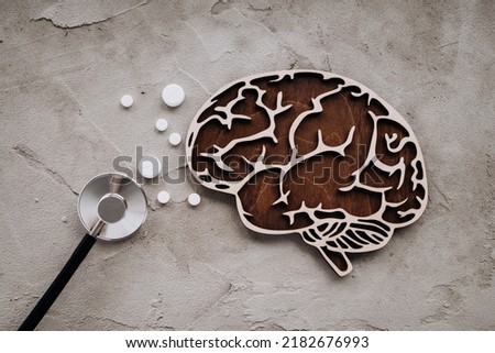 A stethoscope and brain with pills. Awareness of Alzheimer's, Parkinson's disease, dementia, stroke, seizure or mental health. Royalty-Free Stock Photo #2182676993
