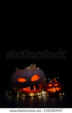 Halloween pumpkins with burning mouthst on dark background.