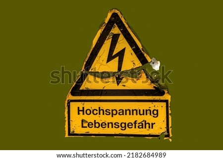Weathered German sign: Hochspannung - Lebensgefahr, engl. high voltage - danger of life. High voltage symbol against green background.